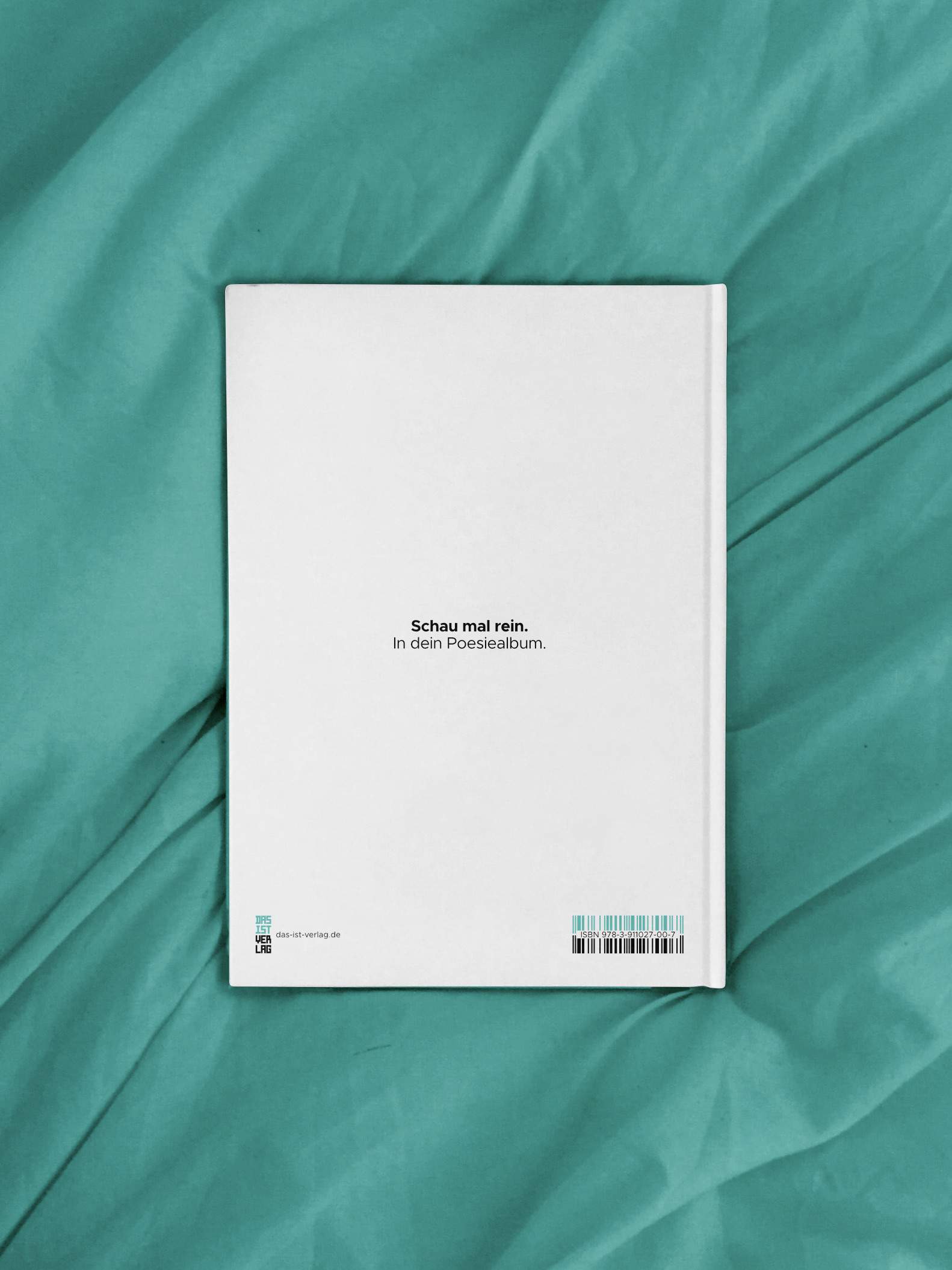 The back cover of the friendship book, reading "Schau mal rein.", on a bed